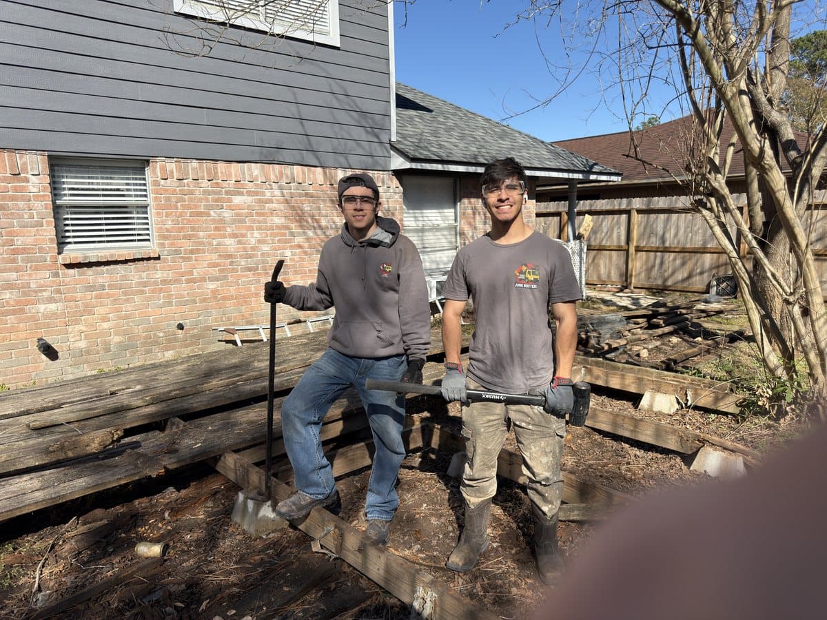 Real mid-project photo of a deck teardown in progress with boards and railings removed in Houston