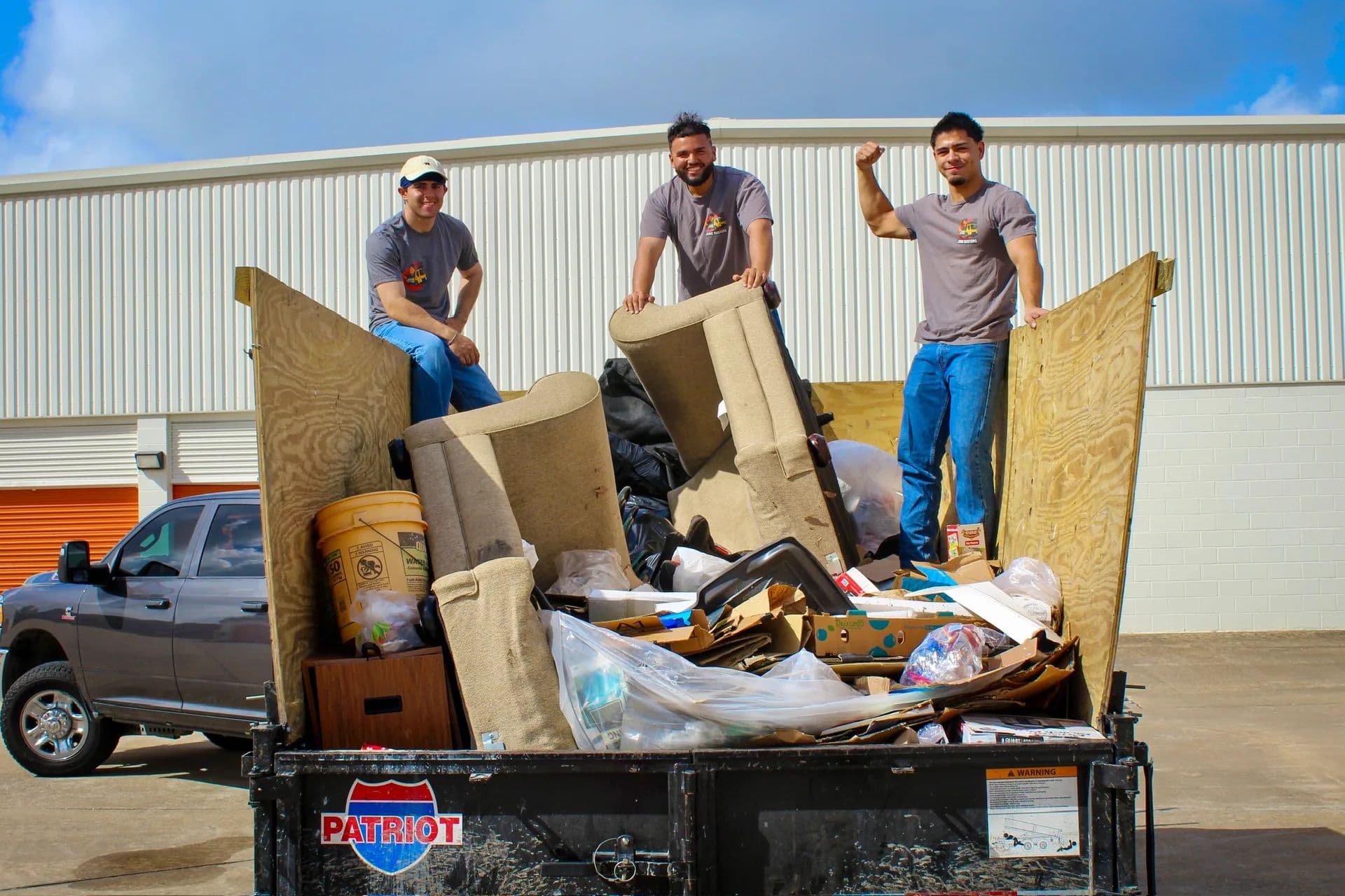 Real job photo of the Junk Busters Houston crew on a loaded pile of demolished debris ready for haul-away