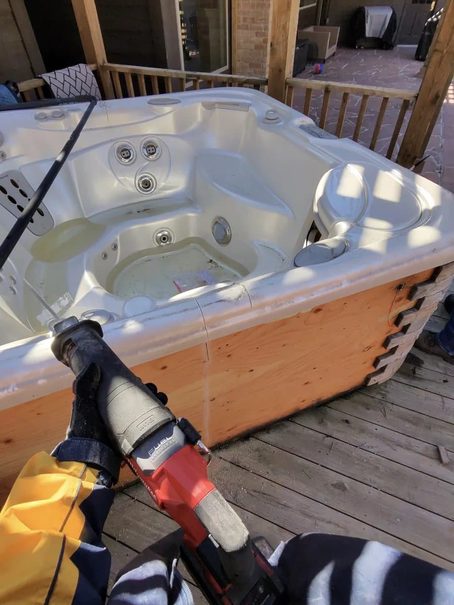 Real before photo of an old hot tub on a backyard patio scheduled for removal in Houston